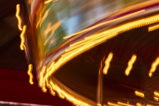 Vibrant long exposure of a carousel in motion at Fort Wayne Children's Zoo, capturing the thrill and colors of nightlife.