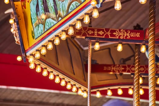 Colorful carousel canopy with vintage lights at Fort Wayne Children's Zoo, Indiana, evoking nostalgic joy.