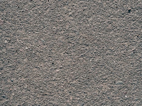 texture of dirty old asphalt with stones close-up