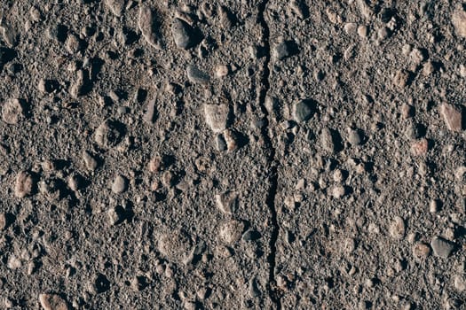 texture of dirty old asphalt with stones close-up
