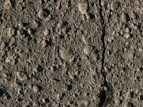 texture of dirty old asphalt with stones close-up