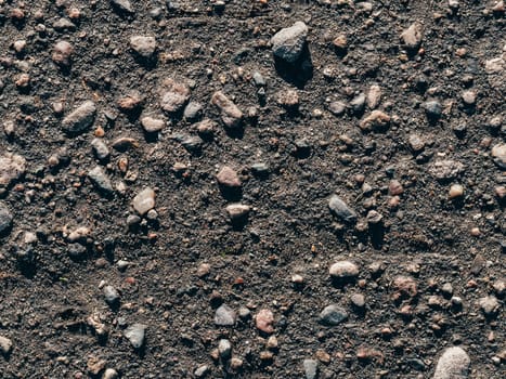 texture of dirty old asphalt with stones close-up