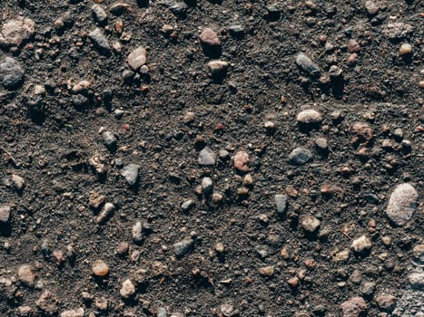 texture of dirty old asphalt with stones close-up