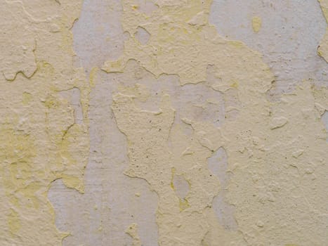 old concrete wall with cracks and peeling paint. Vintage style texture