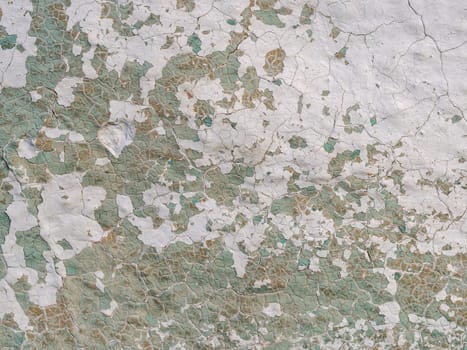 old concrete wall with cracks and peeling paint. Vintage style texture