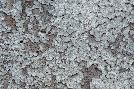 old concrete wall with cracks and peeling paint. Vintage style texture