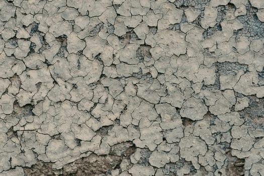 old concrete wall with cracks and peeling paint. Vintage style texture