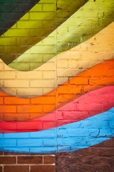 Vibrant geometric mural in Fort Wayne, showcasing colorful urban art on a textured brick wall.