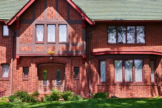 Traditional Tudor-style house in South Wayne Historic District, Indiana, showcasing classic architecture and a lush garden.