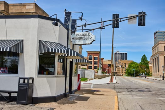 Sunlit Powers Hamburgers diner evokes Americana in downtown Fort Wayne, blending historic charm with urban life.