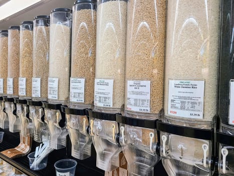 Variety of organic rice in bulk dispensers at a sustainable grocery store in Fort Wayne, Indiana.