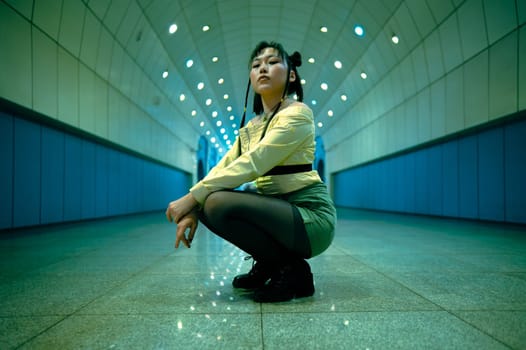 Asian young woman posing in the subway passage