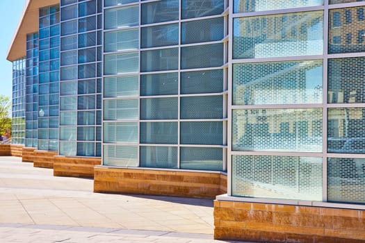 Modern glass and metal architecture at Grand Wayne Convention Center, Fort Wayne under a clear blue sky.