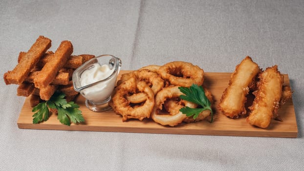 crackers, onion rings and other beer snacks with sauce