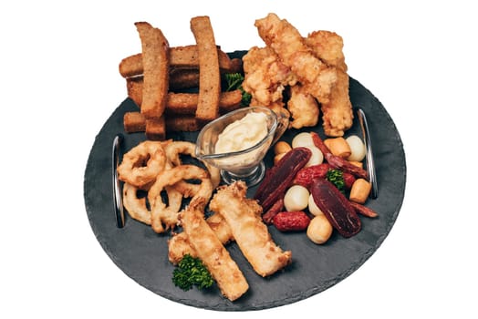 set of snacks for beer with breadcrumbs, sausage, cheese, sauces and onion rings
