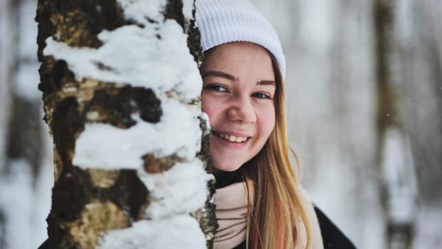 Portrait of a girl in winter in a birch forest