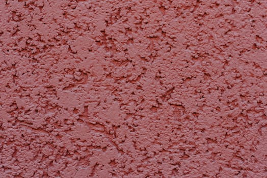 structure of textured plaster on the red wall