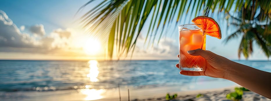 A cocktail in the hands of a girl on the beach. Selective focus. Drink.