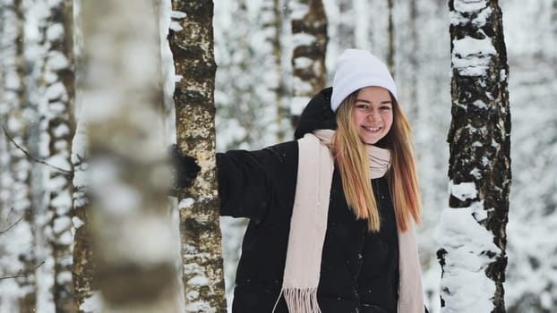 Portrait of a girl in winter in a birch forest
