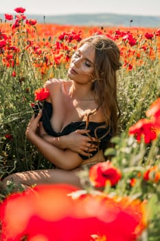 Woman poppies field. portrait of a happy woman with long hair in a poppy field and enjoying the beauty of nature in a warm summer day