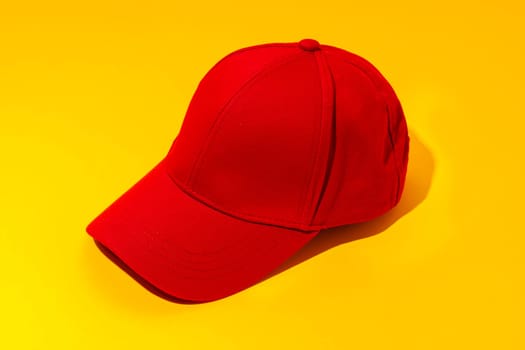 Baseball hat against yellow background in studio close up
