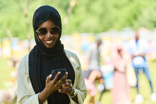 Middle Eastern Muslim woman in a hijab uses a smartphone while managing a small beekeeping business, blending modern technology with traditional practices