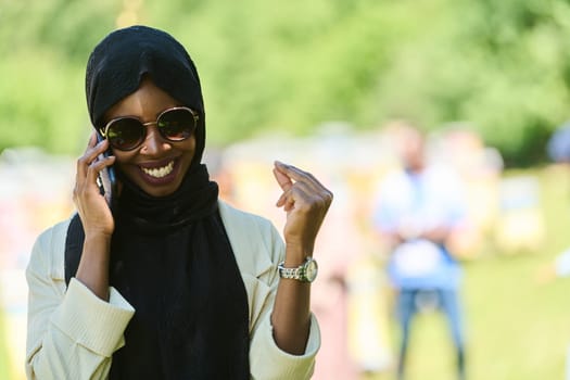 Middle Eastern Muslim woman in a hijab uses a smartphone while managing a small beekeeping business, blending modern technology with traditional practices