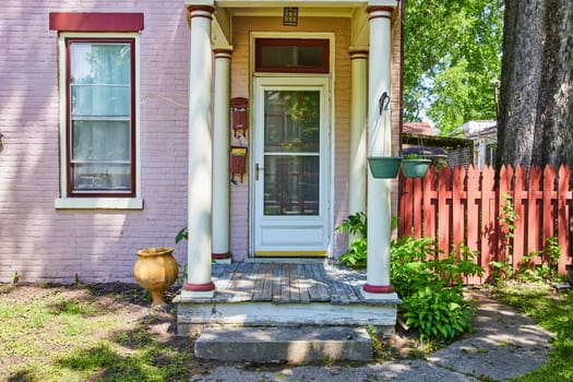 Charming pink brick house with vintage details in Fort Wayne, evoking nostalgia and timeless beauty.