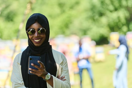 Middle Eastern Muslim woman in a hijab uses a smartphone while managing a small beekeeping business, blending modern technology with traditional practices