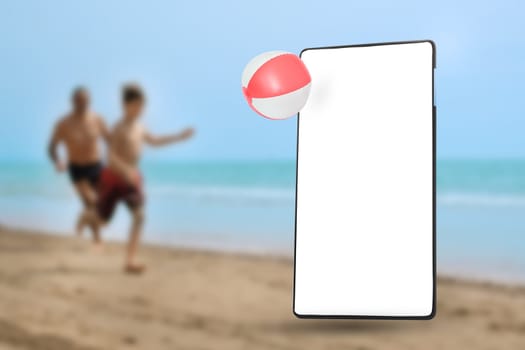 Mobile phone screen on the sandy beach with running people in background.
