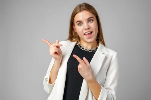 Confident Young Businesswoman Presenting With Hand Gesture in Studio Setting copy space