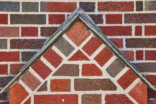 Geometric brickwork with metallic trim in South Wayne Historic District, showcasing craftsmanship and stability.