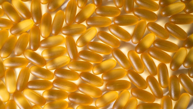 Close-up of golden omega three capsules. Dietary supplement fish oil.