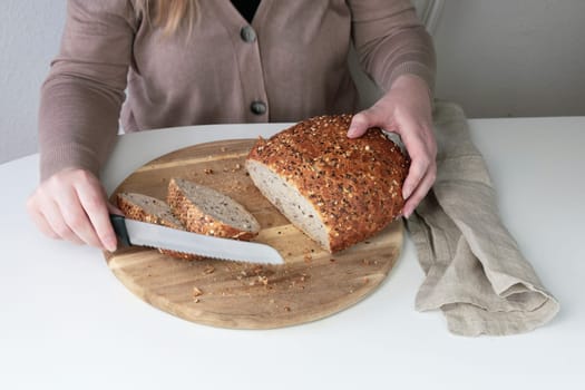 Woman cutting bread on a cutting board. High quality photo