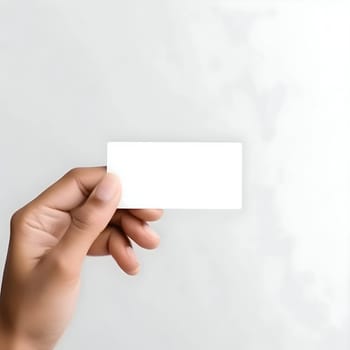 A pair of hands holds a blank white card, waiting to be filled with your creativity and personal touch.