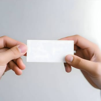 A pair of hands holds a blank white card, waiting to be filled with your creativity and personal touch.