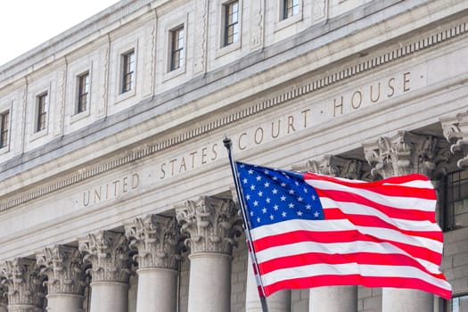 USA national flag waving in the wind in front of United States Court House in New York, USA