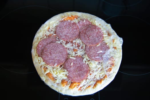 Frozen semi-finished pizza from the supermarket. Fast food concent. High quality photo