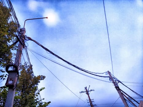 Old pole with wires against the sky. Electric transmission line, Eco-friendly energy