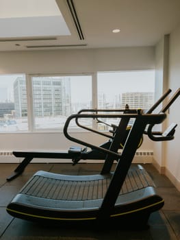An empty treadmill machine awaits its next dedicated runner in the gym.