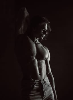 Portrait of sporty handsome muscular man, black and white contrast body texture. Fitness motivation, strengthen muscles, training male gym programs. High quality photo