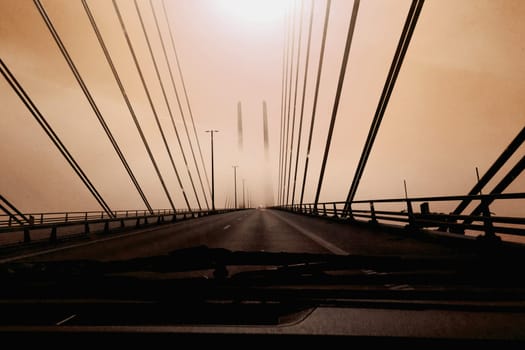 High-speed road bridge view from a fast-moving car. Road and railway blidge connecting Denmark and Sweden.