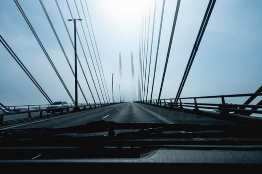 High-speed road bridge view from a fast-moving car. Road and railway blidge connecting Denmark and Sweden.