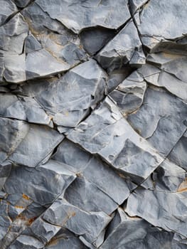 Close-up view of a textured gray slate wall with varied stone sizes and subtle color variations.