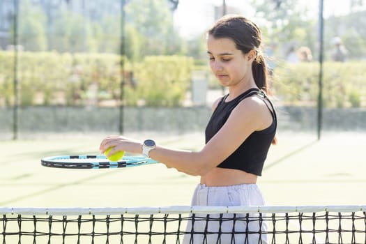Girl with a racket on the tennis court. High quality photo