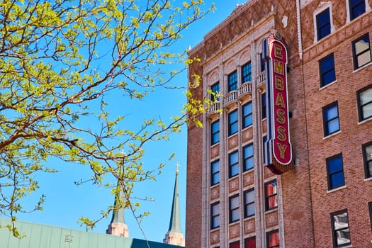 Spring in downtown Fort Wayne: Historic Embassy Theatre under a vivid blue sky with fresh foliage.