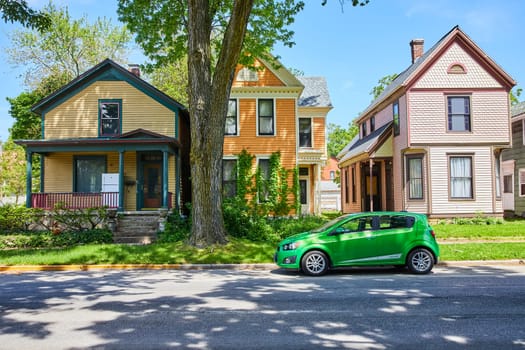 Colorful Victorian homes line a serene street in Fort Wayne, blending historic charm with modern life.