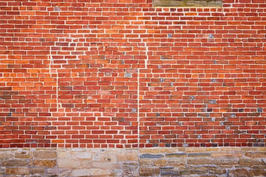 Vivid brick wall with intricate details and natural stone foundation in Fort Wayne, evoking rustic charm and stability.