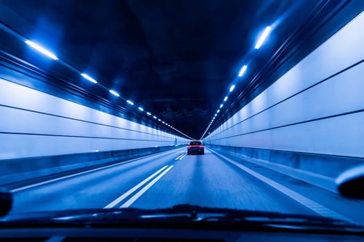 High-speed road tunnel view from a fast-moving car. Road and railway tunnel and blidge connecting Denmark and Sweden.