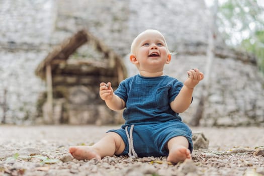 Baby tourist at Coba, Mexico. Ancient mayan city in Mexico. Coba is an archaeological area and a famous landmark of Yucatan Peninsula. Cloudy sky over a pyramid in Mexico.